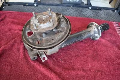 6/76-1978 Datsun 280Z coupe LH driver rear strut housing w/stub axle used OEM